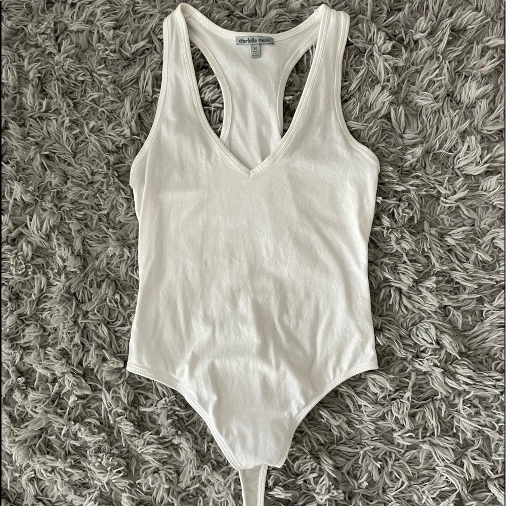 White, low V-Neck body suit. Racerback
